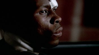 Movie still from “Paid in Full” (2002), directed by Charles Stone III – A person with a bandage on his head; Close Up shot, Low angle