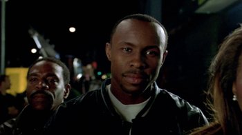 Movie still from “Paid in Full” (2002), directed by Charles Stone III – A person wearing a black jacket; Close Up shot, Low angle