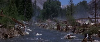 Movie still from “Paint Your Wagon” (1969), directed by Joshua Logan – A group of people in the water near a forest; Extreme Wide shot, High angle