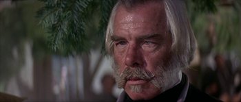 Movie still from “Paint Your Wagon” (1969), directed by Joshua Logan – An older man with a beard and a mustache; Close Up shot, Low angle