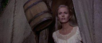 Movie still from “Paint Your Wagon” (1969), directed by Joshua Logan – A woman standing next to a barrel in a room; Close Up shot, Low angle