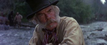 Movie still from “Paint Your Wagon” (1969), directed by Joshua Logan – An old man with a beard and a hat; Close Up shot, Low angle