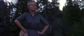 Movie still from “Paint Your Wagon” (1969), directed by Joshua Logan – A woman standing in front of a forest; Medium shot, Low angle