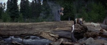 Movie still from “Paint Your Wagon” (1969), directed by Joshua Logan – Two people standing on top of a fallen log; Wide shot, High angle