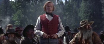 Movie still from “Paint Your Wagon” (1969), directed by Joshua Logan – A man in a red vest and a black bow tie; Medium shot, Low angle