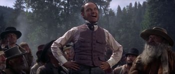 Movie still from “Paint Your Wagon” (1969), directed by Joshua Logan – A man standing in front of a group of people; Medium shot, Low angle