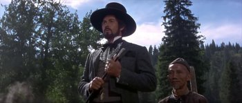 Movie still from “Paint Your Wagon” (1969), directed by Joshua Logan – A man with a beard and a hat holding a pipe; Medium shot, Low angle