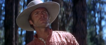 Movie still from “Paint Your Wagon” (1969), directed by Joshua Logan – A man wearing a cowboy hat looking up at the sky; Close Up shot, Low angle