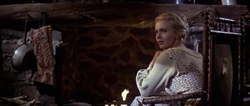 Movie still from “Paint Your Wagon” (1969), directed by Joshua Logan – A woman sitting in front of a fire place; Medium shot, Low angle