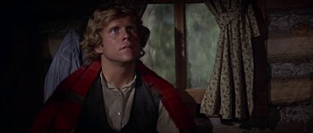 Movie still from “Paint Your Wagon” (1969), directed by Joshua Logan – A man with a red scarf is looking out of a window; Close Up shot, Low angle