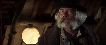 Movie still from “Paint Your Wagon” (1969), directed by Joshua Logan – An older man with a beard and a hat; Close Up shot, Low angle