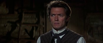 Movie still from “Paint Your Wagon” (1969), directed by Joshua Logan – A man wearing a vest and a neck tie; Close Up shot, Low angle