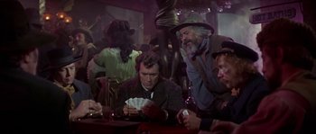 Movie still from “Paint Your Wagon” (1969), directed by Joshua Logan – A group of men sitting at a table playing a card game; Medium shot, Low angle