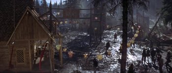 Movie still from “Paint Your Wagon” (1969), directed by Joshua Logan – A group of people walking through a muddy area; Extreme Wide shot, High angle