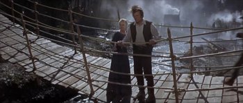 Movie still from “Paint Your Wagon” (1969), directed by Joshua Logan – A man and a woman standing next to each other on a bridge; Wide shot, High angle