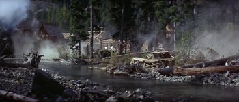 Movie still from “Paint Your Wagon” (1969), directed by Joshua Logan – A river running through a forest filled with debris; Extreme Wide shot, High angle