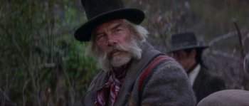 Movie still from “Paint Your Wagon” (1969), directed by Joshua Logan – An old man with a long white beard wearing a hat; Close Up shot, Low angle