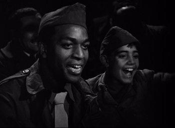 Movie still from “Paisan” (1946), directed by Roberto Rossellini – A black and white photo of two men in military uniforms; Medium shot, Low angle