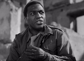 Movie still from “Paisan” (1946), directed by Roberto Rossellini – A black and white photo of a man wearing a hat; Close Up shot, Low angle