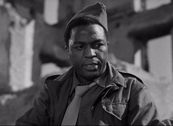 Movie still from “Paisan” (1946), directed by Roberto Rossellini – A black and white photo of a man wearing a hat; Close Up shot, Low angle