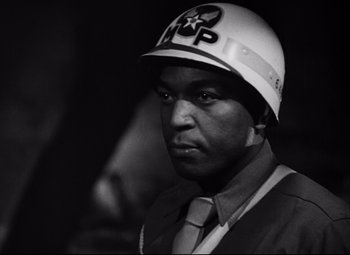 Movie still from “Paisan” (1946), directed by Roberto Rossellini – Black and white photograph of a man wearing a helmet; Close Up shot, Low angle