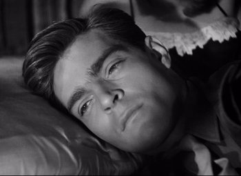 Movie still from “Paisan” (1946), directed by Roberto Rossellini – Black and white photograph of a man sleeping; Close Up shot, High angle