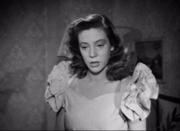 Movie still from “Paisan” (1946), directed by Roberto Rossellini – A black - and - white photo of a woman in a dress; Close Up shot, Low angle