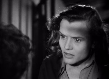 Movie still from “Paisan” (1946), directed by Roberto Rossellini – A young man with a long hair is looking at the camera; Close Up shot, High angle