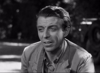 Movie still from “Paisan” (1946), directed by Roberto Rossellini – An old photo of a man in a suit and tie; Close Up shot, High angle