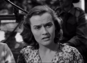 Movie still from “Paisan” (1946), directed by Roberto Rossellini – An old photo of a woman in a floral dress; Close Up shot, High angle