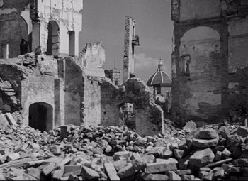 Movie still from “Paisan” (1946), directed by Roberto Rossellini – A black and white photo of a building that has been destroyed; Extreme Wide shot, Low angle