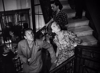 Movie still from “Paisan” (1946), directed by Roberto Rossellini – A man and a woman on the stairs of a building; Medium shot, Low angle