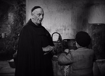 Movie still from “Paisan” (1946), directed by Roberto Rossellini – An old man and a woman are standing together; Medium shot, Over the shoulder angle