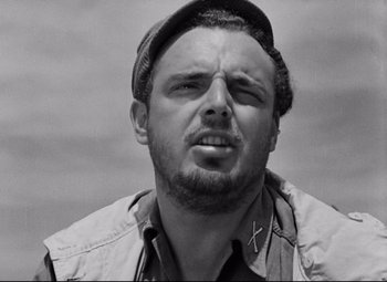 Movie still from “Paisan” (1946), directed by Roberto Rossellini – Black and white photograph of a man with a hat; Close Up shot, Low angle