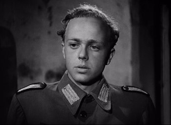 Movie still from “Paisan” (1946), directed by Roberto Rossellini – A man in a military uniform is posing for a picture; Close Up shot, Low angle