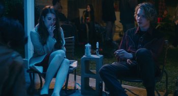 Movie still from “Palo Alto” (2013), directed by Gia Coppola – A man and a woman sitting on a chair; Medium shot, Over the shoulder angle