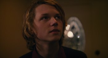 Movie still from “Palo Alto” (2013), directed by Gia Coppola – A man with long blonde hair looking to his left; Close Up shot, Low angle