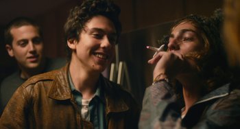 Movie still from “Palo Alto” (2013), directed by Gia Coppola – Two young men are smoking a cigarette together; Close Up shot, Over the shoulder angle
