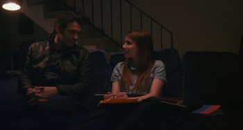 Movie still from “Palo Alto” (2013), directed by Gia Coppola – A man and a woman sitting in a theater; Medium shot, Over the shoulder angle