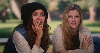 Movie still from “Palo Alto” (2013), directed by Gia Coppola – Two women sitting next to each other on a park bench; Close Up shot, High angle