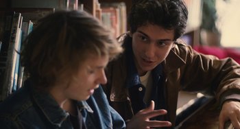 Movie still from “Palo Alto” (2013), directed by Gia Coppola – Two young men are talking to each other in a library; Close Up shot, Over the shoulder angle