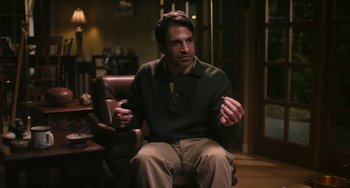 Movie still from “Palo Alto” (2013), directed by Gia Coppola – A man sitting in a chair talking to someone; Medium shot, Over the shoulder angle