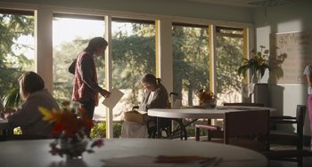 Movie still from “Palo Alto” (2013), directed by Gia Coppola – Two people standing in a room near a table; Wide shot, Over the shoulder angle