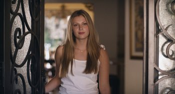 Movie still from “Palo Alto” (2013), directed by Gia Coppola – A beautiful young lady standing in a room; Close Up shot, Low angle