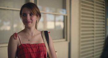 Movie still from “Palo Alto” (2013), directed by Gia Coppola – A woman in a red dress with a purse; Close Up shot, Over the shoulder angle