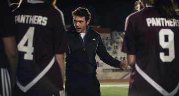 Movie still from “Palo Alto” (2013), directed by Gia Coppola – A man in black jacket talking to a group of people; Medium shot, Over the shoulder angle