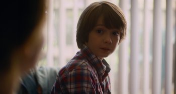 Movie still from “Palo Alto” (2013), directed by Gia Coppola – A young boy in a red and blue plaid shirt; Close Up shot, Over the shoulder angle