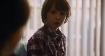 Movie still from “Palo Alto” (2013), directed by Gia Coppola – A boy in a plaid shirt is looking at the camera; Close Up shot, Over the shoulder angle