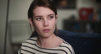Movie still from “Palo Alto” (2013), directed by Gia Coppola – A person sitting on a couch; Close Up shot, Over the shoulder angle