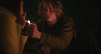 Movie still from “Palo Alto” (2013), directed by Gia Coppola – A person lighting a cigarette in the dark; Medium shot, Over the shoulder angle